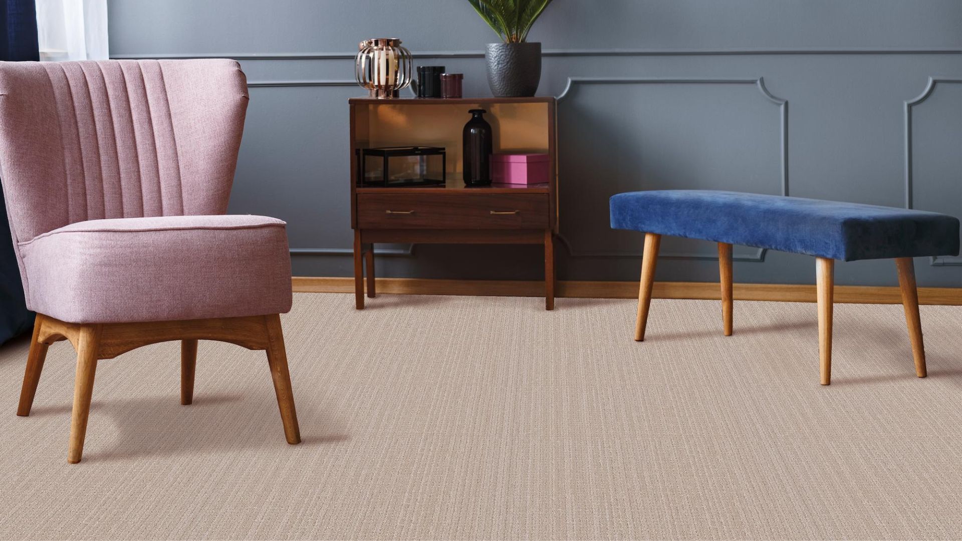 textured beige carpets in a stylish living room with pink chair and blue accent wall